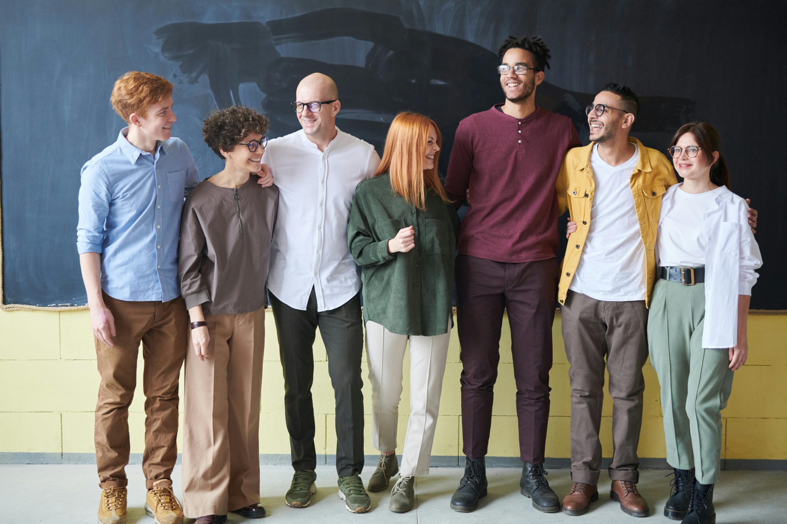 Diverse group of people standing looking at the camera